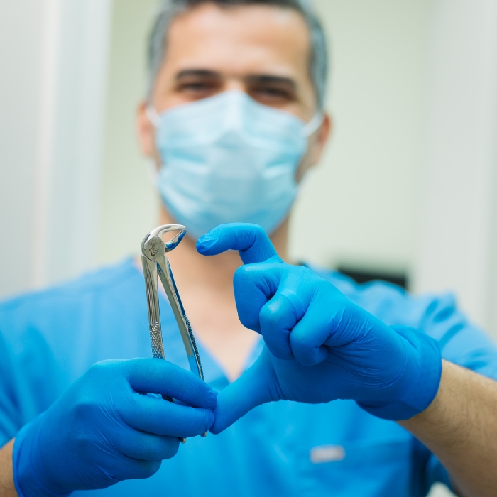 Dental professional showing heart gesture with medical gloves